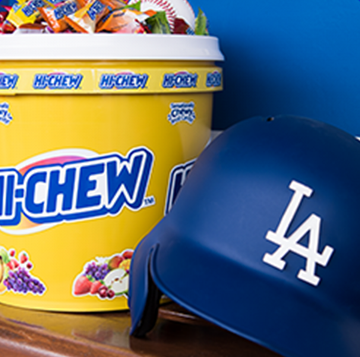 A bucket of Hi-Chew next to an LA Dodgers helmet